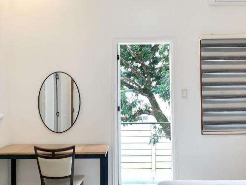 a dining room with a mirror and a table at Koregon Pool Villas in Fort Stotsenburg