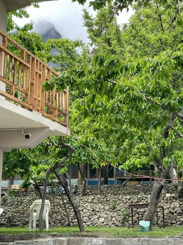 a tree that has been uprootingoting a house at DIAMOND Hotel and Resort in Dargai