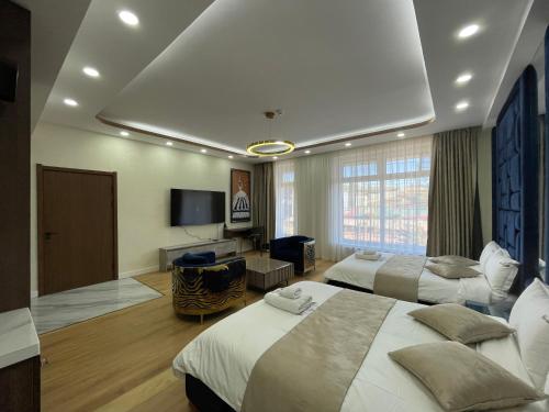 a hotel room with two beds and a television at Numt Guren Resort in Ulaanbaatar