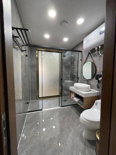 a bathroom with a shower and a toilet and a sink at Numt Guren Resort in Ulaanbaatar