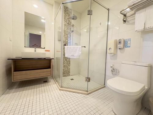 a bathroom with a shower and a toilet and a sink at Tc慢旅花蓮館-近東大門夜市市中心 in Hualien City