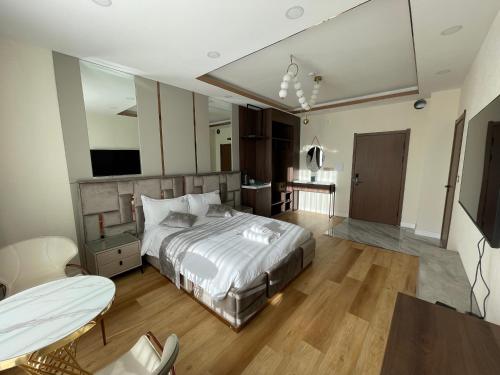 a bedroom with a bed and a table and chairs at Numt Guren Resort in Ulaanbaatar