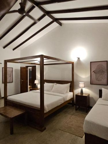 a bedroom with a large bed with a wooden frame at The 6th Milepost Tea Bungalow Bandarawela in Bandarawela