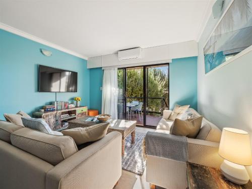 a living room with two couches and a tv at A Beachy Place - Gnarabup in Gnarabup