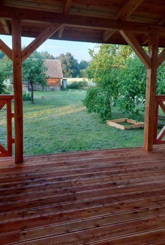 a wooden deck with a view of a field at Niemirowska Osada in Niemirów