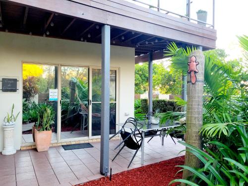 a house with a patio with a table and chairs at Beachside One Bedroom Flat Retreat in Maroochydore