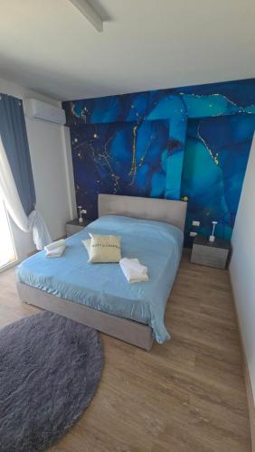 a bedroom with a blue bed with a blue wall at Cerry's Apartments Fronte Mare - Seaside & Sealight in Fossacesia