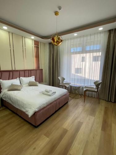 a bedroom with a large bed and a table at Numt Guren Resort in Ulaanbaatar