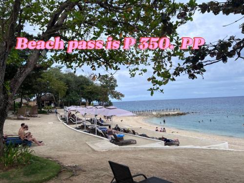 a beach with a sign that reads beach pass is at Mactan Newtown 2 Bedroom near Mactan Airport in Punta Engaño