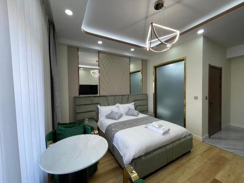 a bedroom with a bed and a table in it at Numt Guren Resort in Ulaanbaatar