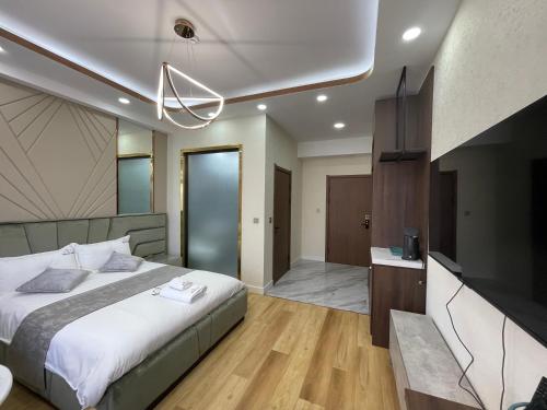 a bedroom with a bed and a flat screen tv at Numt Guren Resort in Ulaanbaatar