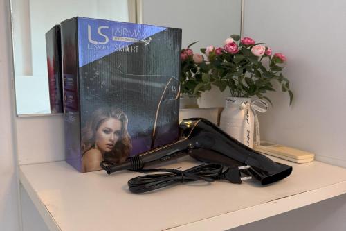 a book and a hair dryer sitting on a shelf at Spacious 1 Bedroom, with sofa bed and Balcony in Kathu