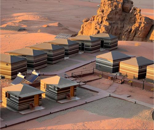 an aerial view of a group of buildings in the desert at Star Wars luxury camp in Wadi Rum