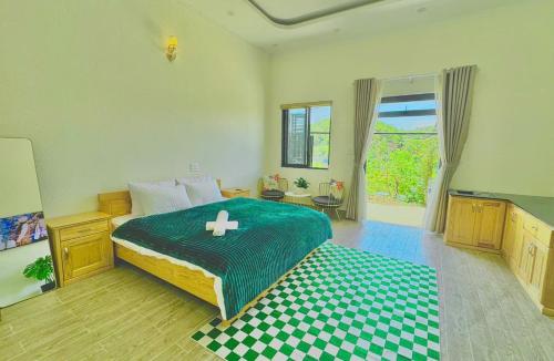 a bedroom with a bed with a cross on it at Pine Forest House Dalat in Xuan An