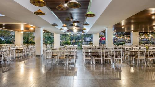 a banquet hall with white chairs and tables at The Wujil Resort & Conventions in Ungaran