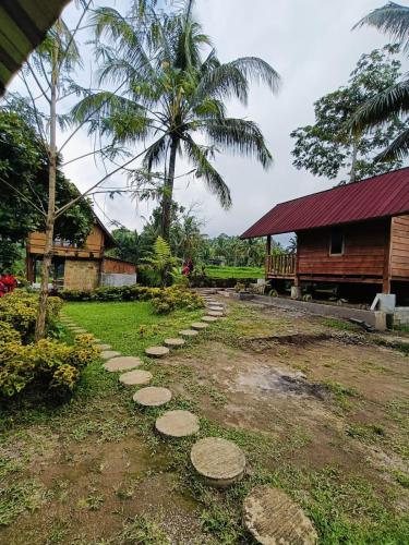 a stepping stone path in front of a house at Dewi Rinjani Homestay in Tetebatu