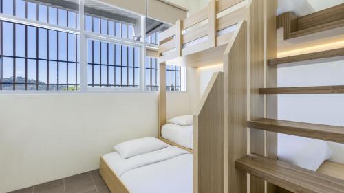 a room with two beds and a window at The Wujil Resort & Conventions in Ungaran