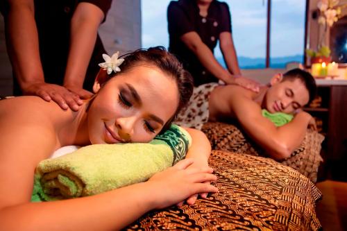 two women laying on beds getting a massage at PRIME PARK Hotel Bandung in Bandung