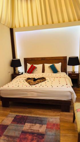 a bedroom with a bed with two lamps and a rug at Star Wars luxury camp in Wadi Rum