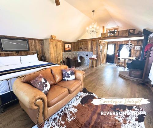 a living room with a couch and a bed at Riversong Inn Retreat in Estes Park