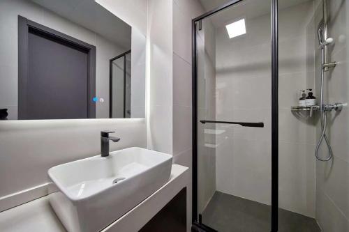 a white bathroom with a sink and a shower at Le Chao Select Hotel in Shanghai