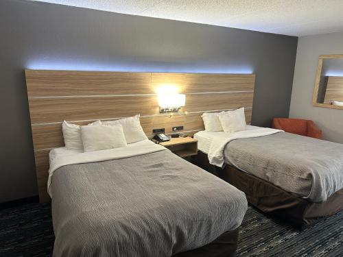 a hotel room with two beds and a desk at Quality Inn Rochester South in Rochester