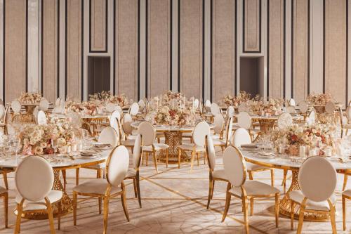 a banquet hall with tables and chairs with flowers at One&Only One Za'abeel in Dubai