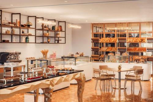 a bakery with a table and chairs in a room at One&Only One Za'abeel in Dubai