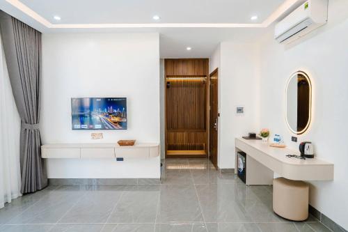 a hotel room with a reception desk and a hallway at Sunflower Hotel in Sầm Sơn