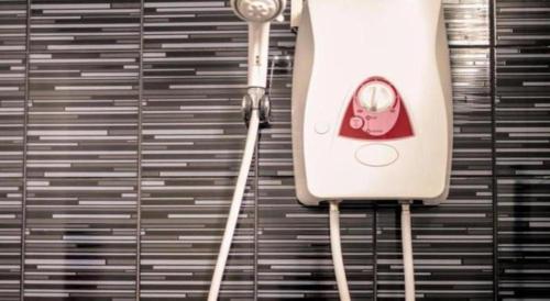 a close up of a hair dryer hanging from a wall at Klang Muang @ Nongkhai Hotel in Nong Khai