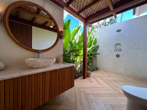 a bathroom with a sink and a mirror at Loku Kedungu - Boutique Resort in Tanah Lot