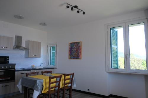 a kitchen with a table and chairs and a window at Nervi, sea view in Genova