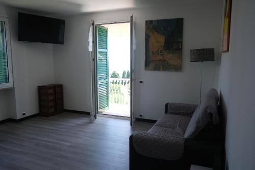 a living room with a couch and a sliding glass door at Nervi, sea view in Genova