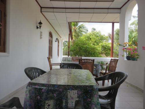 a dining room with a table and chairs at Bentota Home Stay in Bentota