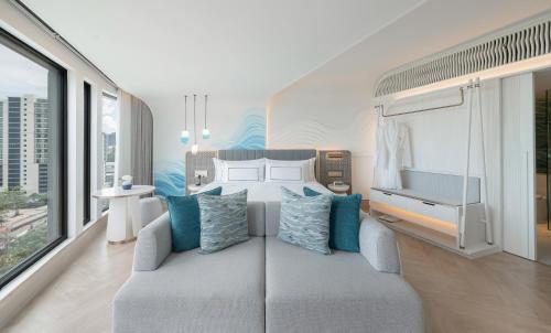 a bedroom with a couch and a bed with a view at Meliá Pattaya Hotel in Pattaya Central