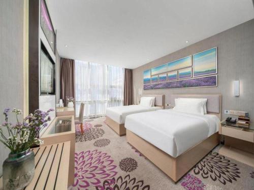 a hotel room with two beds and a large window at Lavande Hotels Urumqi Xinmin West Street Hongda Plaza in Ürümqi