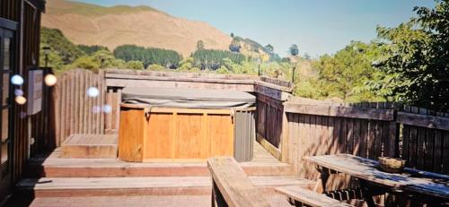 a wooden deck with a bed on top of it at Rough Meadows - MTB Haven & Good Vibes Retreat in Rotorua