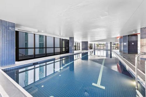 a large swimming pool in a building at Stunning River View 2-Bed with Pool, Sauna and Gym in Brisbane