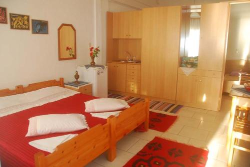 a bedroom with a large bed and a kitchen at Villa Maria in Kamariotissa