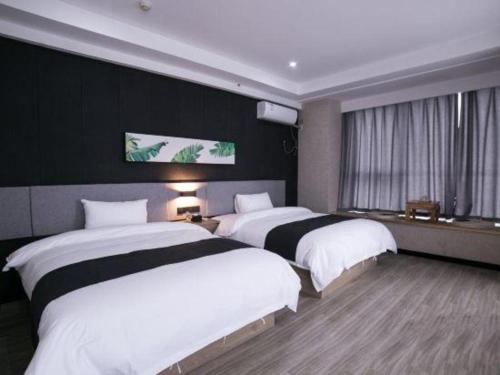 Katil atau katil-katil dalam bilik di UP and IN Hotel Shandong Jinan Zhangqiu District Railway Jiaoyue Plaza