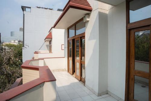a facade of a white house with a wooden door at Ahuja Residency DLF Phase 2 in Gurgaon
