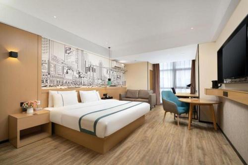 a hotel room with a large bed and a television at City Comfort Inn Nanning Exhibition Center Hangyang City Metro Station in Nanning