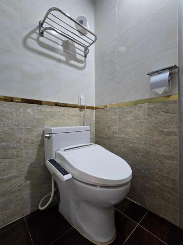 a bathroom with a white toilet in a room at Jardin Hotel in Seoul