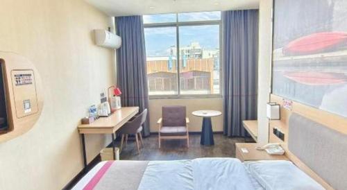 a hotel room with a bed and a desk and a window at Thank Inn Plus Hotel Guangdong Yunfu Luoding City Municipal in Yunfu