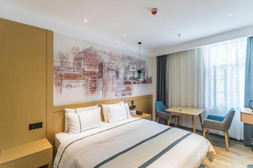 a hotel room with a large bed and a desk at City Comfort Inn Lhasa Potala Palace Scenic View in Lhasa