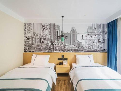two beds in a room with a drawing of a city at City Comfort Inn Lhasa Potala Palace Scenic View in Lhasa