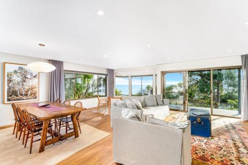 a living room with a table and a couch at Chinamans at Hyams Beach in Hyams Beach
