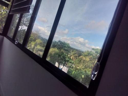 a view through a window of a forest at Varietyvilla Homestay in Kattappana