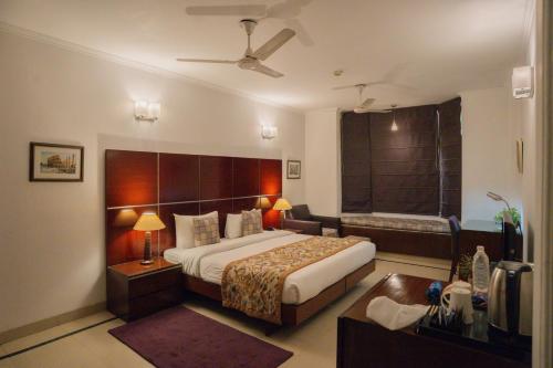 a hotel room with a bed and a bathroom at Ahuja Residency DLF Phase 2 in Gurgaon