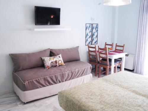 a living room with a couch and a table at Saint Nicholas Beach Resort in Dassia